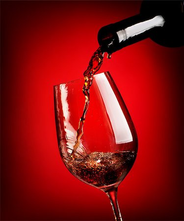simsearch:400-04264239,k - Red wine pouring in a wineglass on a red background Stock Photo - Budget Royalty-Free & Subscription, Code: 400-08164825
