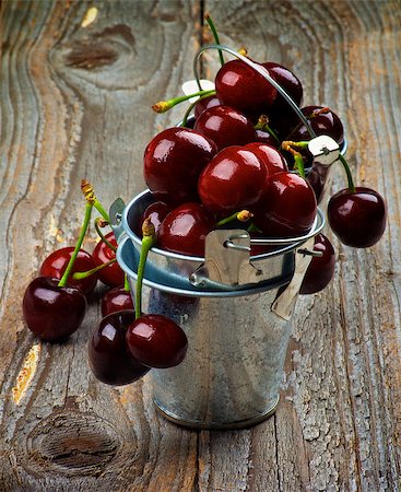 simsearch:400-08020671,k - Sweet Dark Red Cherries in Full of Tin Buckets closeup on Rustic Wooden background Stock Photo - Budget Royalty-Free & Subscription, Code: 400-08165069