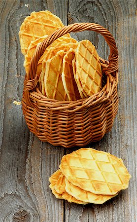 simsearch:400-07420117,k - Heap of Crunchy Thin Waffles in Wicker Basket closeup on Rustic Wooden background Stock Photo - Budget Royalty-Free & Subscription, Code: 400-08165157