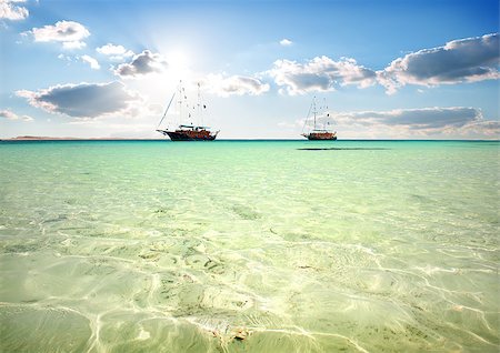 Two sailboats in turquoise sea under sunlight Stock Photo - Budget Royalty-Free & Subscription, Code: 400-08166393