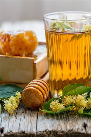 simsearch:400-04691031,k - Linden tea in a glass and honey  on a wooden table. Photographie de stock - Aubaine LD & Abonnement, Code: 400-08160484