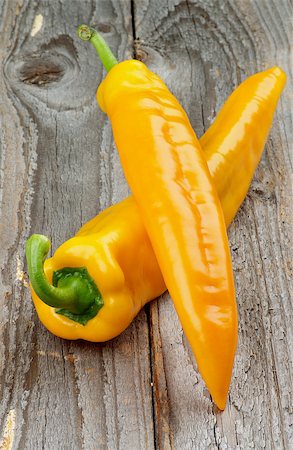 poivre de cayenne - Two Perfect Ripe Yellow Ramiro Peppers isolated on Rustic Wooden background Photographie de stock - Aubaine LD & Abonnement, Code: 400-08160580