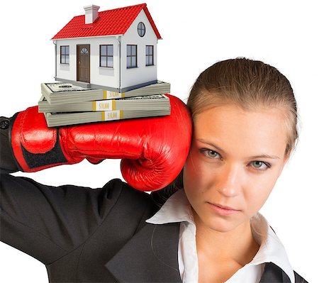 simsearch:400-08161703,k - Businesswoman in boxing gloves with bundle of money and house looking at camera on isolated white background Photographie de stock - Aubaine LD & Abonnement, Code: 400-08161691