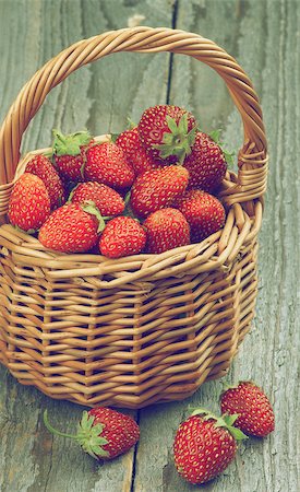 simsearch:400-08020671,k - Fresh Ripe Forest Strawberries in Wicker Basket isolated on Rustic Wooden background. Retro Styled Stock Photo - Budget Royalty-Free & Subscription, Code: 400-08161944