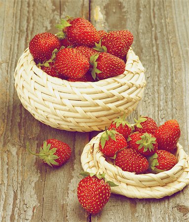 simsearch:400-08020671,k - Fresh Ripe Forest Strawberries in Wicker Bowls isolated on Rustic Wooden background. Retro Styled Stock Photo - Budget Royalty-Free & Subscription, Code: 400-08161940