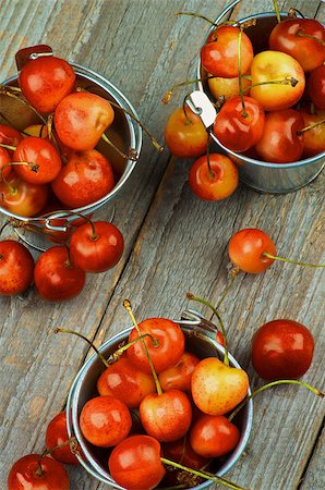 Three Tin Buckets Full of Sweet Maraschino Cherries on Rustic Wooden background. Top View Photographie de stock - Aubaine LD & Abonnement, Code: 400-08161955