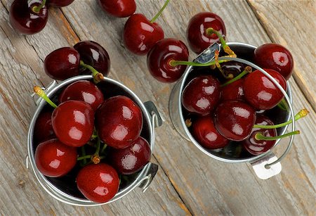 simsearch:400-08020671,k - Tin Buckets Full of Sweet Dark Red Cherries closeup on Rustic Wooden background. Top View Stock Photo - Budget Royalty-Free & Subscription, Code: 400-08163152