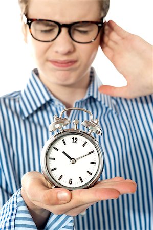 pic of male kids disturbed - Boy irritated with noise of alarm clock isolated over white Stock Photo - Budget Royalty-Free & Subscription, Code: 400-08185042