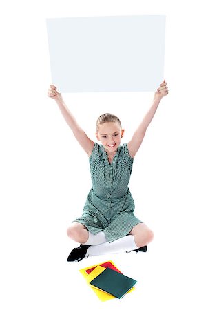 simsearch:400-06695536,k - Attractive girl displaying blank whiteboard over her head, sitting on floor Stock Photo - Budget Royalty-Free & Subscription, Code: 400-08185077