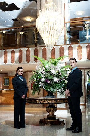 Smartly dressed front office executives posing under a chandler with flower vase as a centerpiece Stock Photo - Budget Royalty-Free & Subscription, Code: 400-08185211