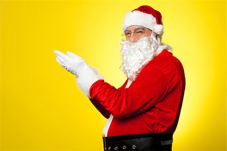 portrait picture adam and eve - Side profile of Santa facing camera with open palms. All on yellow background. Stock Photo - Budget Royalty-Free & Subscription, Code: 400-08185654