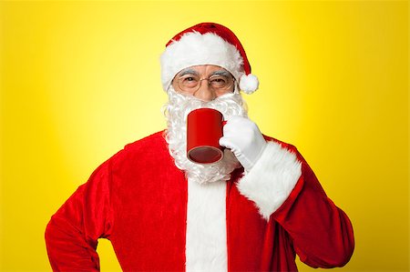 pic of drinking celebration for new year - Relaxed Santa enjoying his cup of coffee. Isolated against yellow background. Stock Photo - Budget Royalty-Free & Subscription, Code: 400-08185680