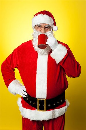 pic of drinking celebration for new year - Portrait of a aged Santa sipping coffee. Hand on his waist. Stock Photo - Budget Royalty-Free & Subscription, Code: 400-08185681