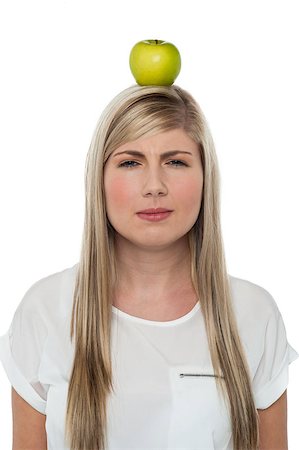 fruit head balance - Attractive woman concentrating hard on balancing an apple on her head. Stock Photo - Budget Royalty-Free & Subscription, Code: 400-08185910