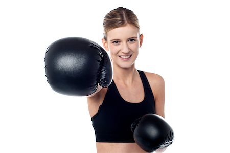 simsearch:400-07036748,k - Pretty teen showing you punch wearing black boxing gloves Foto de stock - Royalty-Free Super Valor e Assinatura, Número: 400-08186780