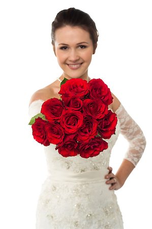 simsearch:400-05208182,k - Beautiful bride with one hand on waist displaying a bunch of red roses Foto de stock - Royalty-Free Super Valor e Assinatura, Número: 400-08186808