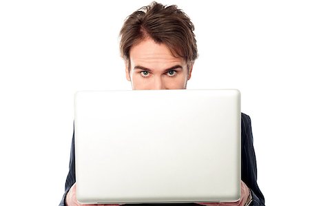 simsearch:400-07514126,k - Serious male manager hiding face behind laptop Fotografie stock - Microstock e Abbonamento, Codice: 400-08186933