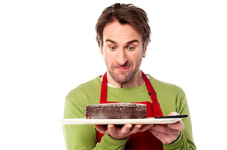 eyes birthday cake - Young chef staring at chocolate cake while holding it Stock Photo - Budget Royalty-Free & Subscription, Code: 400-08186979