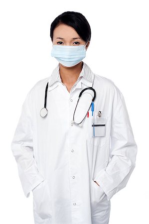 simsearch:400-08131186,k - Young female surgeon wearing a face mask Stock Photo - Budget Royalty-Free & Subscription, Code: 400-08187114