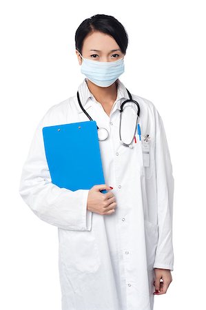 simsearch:400-08131186,k - Young female physician wearing surgical mask and holding clipboard Stock Photo - Budget Royalty-Free & Subscription, Code: 400-08187112