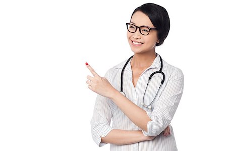 simsearch:400-08131186,k - Young smiling casual female doctor looking and pointing away Foto de stock - Royalty-Free Super Valor e Assinatura, Número: 400-08187140