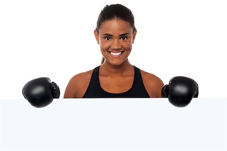Smiling young boxing woman posing from behind a blank whiteboard. Photographie de stock - Aubaine LD & Abonnement, Code: 400-08187361