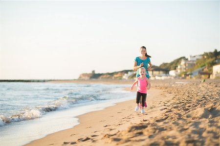 The freedom of running along the water at the beach is made even more special for a little girl, as her mother runs behind her, letting her daughter get ahead. Stock Photo - Budget Royalty-Free & Subscription, Code: 400-08194016