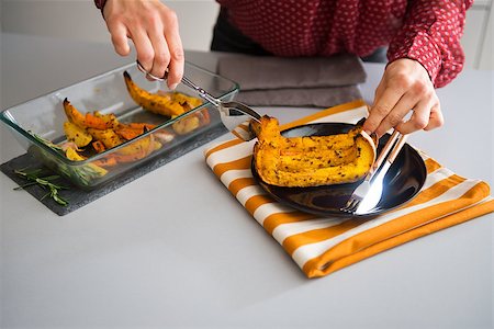 simsearch:400-07956018,k - An elegant woman's hands are service a slice of roasted pumpkin onto a dark plate. The tea-towel below the plate brings out the pumpkin and autumn colors. Stockbilder - Microstock & Abonnement, Bildnummer: 400-08196819