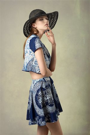 simsearch:400-08890472,k - fashion portrait of charming brunette woman in cute pose with summer hat and blue printed top and skirt, trendy spring summer clothes. Looking in camera Stockbilder - Microstock & Abonnement, Bildnummer: 400-08197235