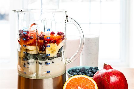 simsearch:640-01358873,k - Prepared smoothies and healthy smoothie ingredients in blender with fresh fruit ready to blend on kitchen table Stock Photo - Budget Royalty-Free & Subscription, Code: 400-08197375