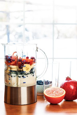 photos of blueberries for kitchen - Healthy smoothie ingredients in blender with fresh fruit ready to blend on kitchen table Foto de stock - Super Valor sin royalties y Suscripción, Código: 400-08197373