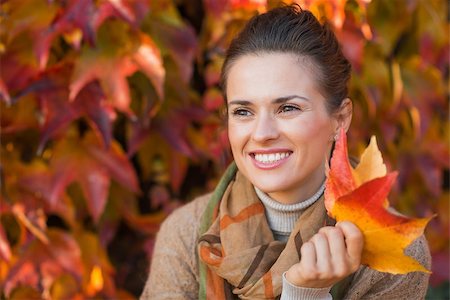 simsearch:400-06520162,k - Portrait of pensive young woman with leafs in front of autumn foliage Stock Photo - Budget Royalty-Free & Subscription, Code: 400-08198976