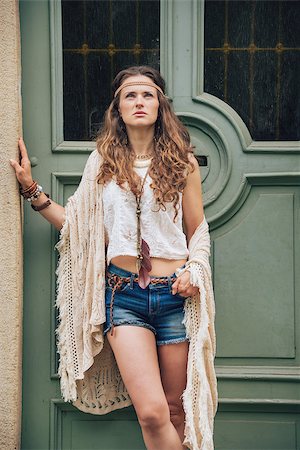 simsearch:400-08194027,k - Portrait of young woman wearing boho clothes standing outdoors against wooden door in old town Photographie de stock - Aubaine LD & Abonnement, Code: 400-08198988