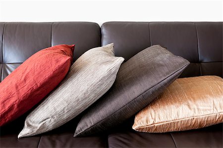 Four colorful cushions on dark brown leather couch Stock Photo - Budget Royalty-Free & Subscription, Code: 400-08199803