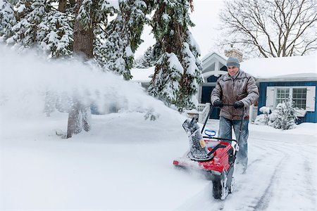 driveway winter - Man using snowblower to clear deep snow on driveway near residential house after heavy snowfall. Stock Photo - Budget Royalty-Free & Subscription, Code: 400-08199828