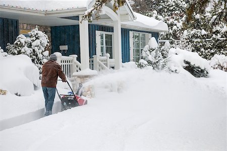 elenathewise (artist) - Man using snowblower to clear deep snow on driveway near residential house after heavy snowfall Stock Photo - Budget Royalty-Free & Subscription, Code: 400-08199830