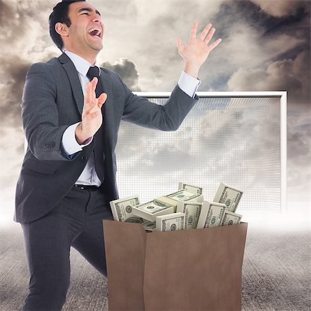 Excited businessman catching against blue sky Stock Photo - Budget Royalty-Free & Subscription, Code: 400-08200472