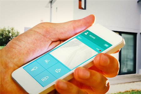 hand holding smartphone against home automation system Photographie de stock - Aubaine LD & Abonnement, Code: 400-08200831