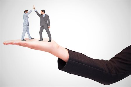 simsearch:400-07664794,k - Businessmen high fiving against white background with vignette Stock Photo - Budget Royalty-Free & Subscription, Code: 400-08224820