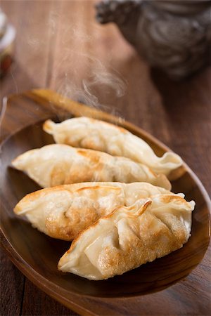 simsearch:400-08225258,k - Fresh pan fried dumplings on plate with hot steams. Asian food on rustic old vintage wooden background. Foto de stock - Super Valor sin royalties y Suscripción, Código: 400-08224985