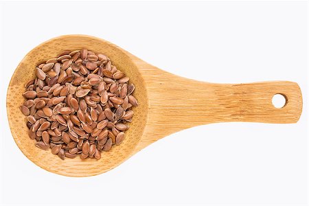 brown flax seeds on a small wooden spoon isolated on white with a clipping path Photographie de stock - Aubaine LD & Abonnement, Code: 400-08222404