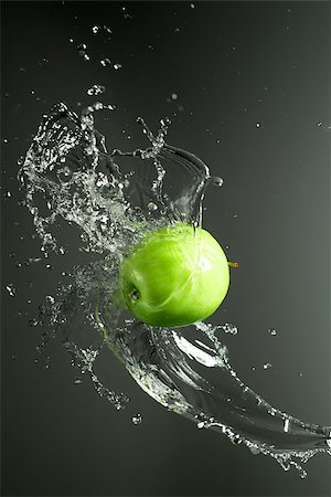 Green apple with water splash on black background Stock Photo - Budget Royalty-Free & Subscription, Code: 400-08222519