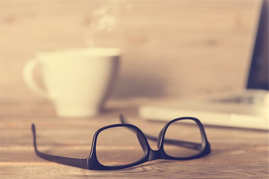 Wooden work table with glasses, laptop, cup of hot coffee, in dramatic light vintage toned. Stock Photo - Royalty-Free, Artist: szefei, Image code: 400-08223422