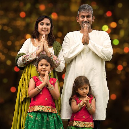 simsearch:400-08223620,k - Indian family greeting on Diwali, festival of lights, inside a temple. Stock Photo - Budget Royalty-Free & Subscription, Code: 400-08223622
