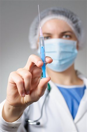 Female doctor with syringe and face mask Stock Photo - Budget Royalty-Free & Subscription, Code: 400-08254009