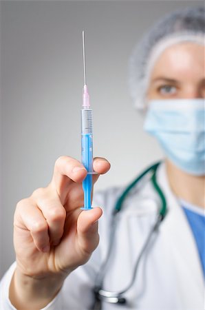 Female doctor with syringe and face mask Stock Photo - Budget Royalty-Free & Subscription, Code: 400-08254063