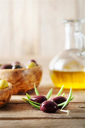 simsearch:400-05666507,k - olives on olive branch. Wooden table with olives and olive oil Stock Photo - Budget Royalty-Free & Subscription, Code: 400-08254079