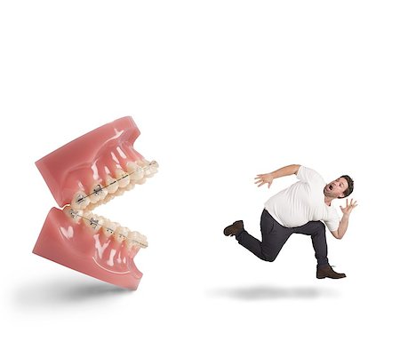 Man runs away for fear of dentist Stock Photo - Budget Royalty-Free & Subscription, Code: 400-08254176