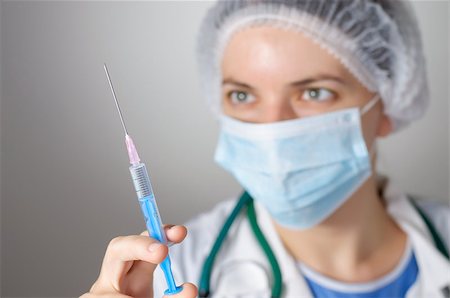 Female doctor with syringe and face mask Stock Photo - Budget Royalty-Free & Subscription, Code: 400-08254724