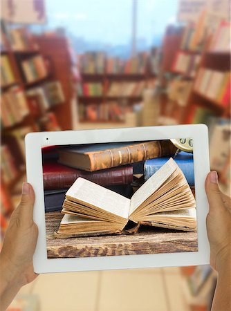 simsearch:400-04856402,k - Hands holding  tablet with open book on screen library shelfs in background, e-learning concept Stock Photo - Budget Royalty-Free & Subscription, Code: 400-08254946